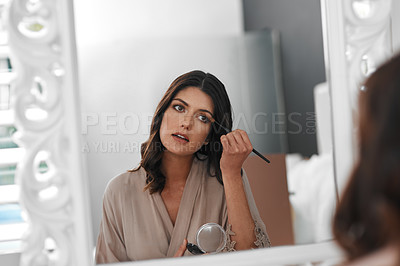 Buy stock photo Shot of a woman applying makeup for a special occasion