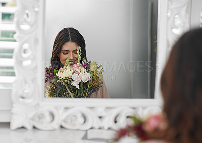 Buy stock photo Smelling flowers, woman and mirror for beauty routine, wearing robe and bride to be in bedroom. Female person, bouquet and makeup in dressing room for wedding, relaxation and happy at home or venue