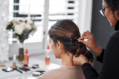 Buy stock photo Rearview shot of a woman getting her hair done by her hairstylist