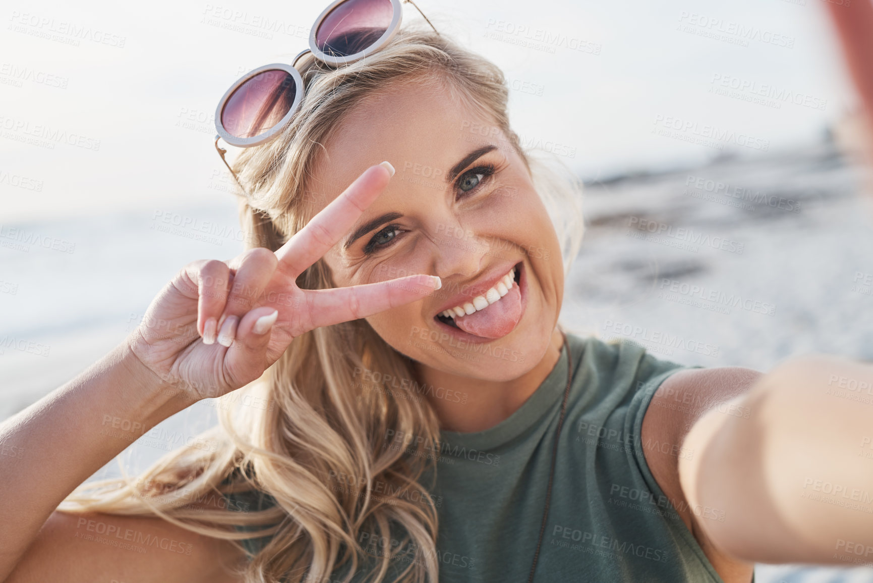 Buy stock photo Woman, peace sign and happy selfie by sea with tongue, summer vacation and online blog update. Girl face, v emoji and profile picture at beach for social media, holiday trip and gap year in Florida