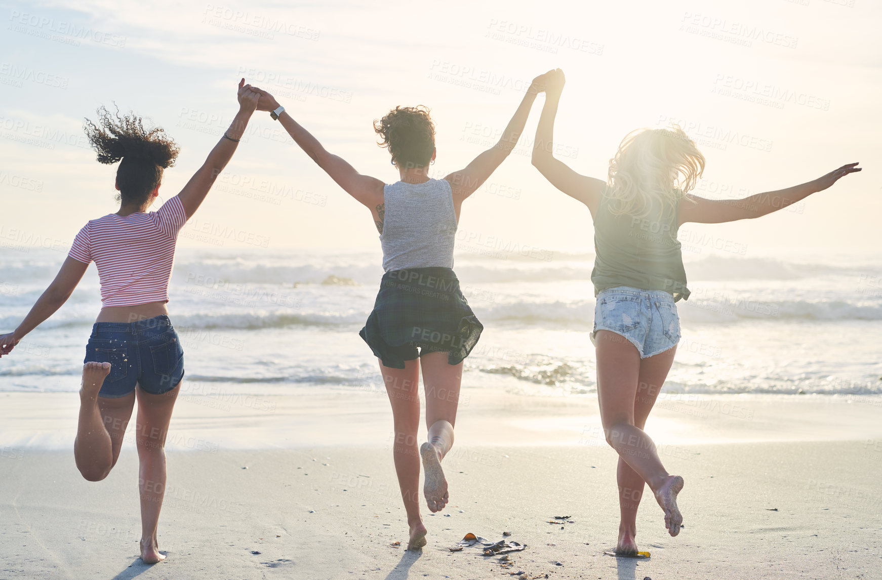 Buy stock photo Back, group and women on beach for hands up, freedom and bonding together on vacation in California. Sand, waves and celebration of friends for travel fun, adventure and cheerful on holiday in ocean