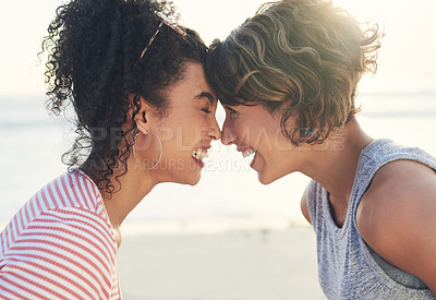 Buy stock photo Cropped shot of two female friends spending the day at the beach