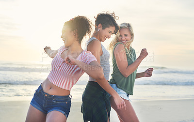 Buy stock photo Shot of three friends spending the day at the beach