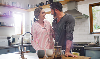 Buy stock photo Cropped shot of an affectionate couple standing in the kitchen at home