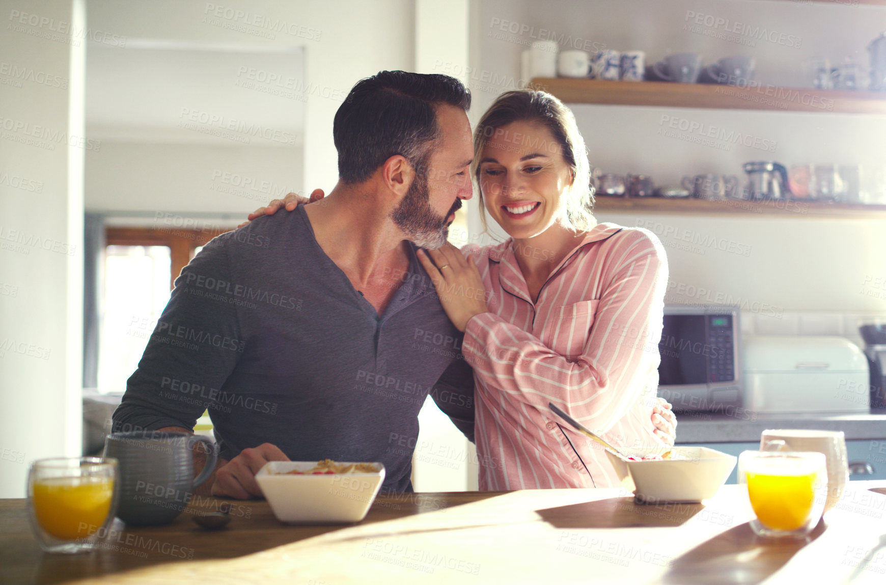 Buy stock photo Cropped shot of a middle aged couple having breakfast at home
