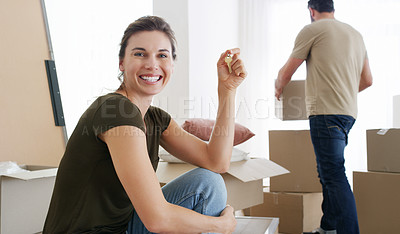 Buy stock photo Shot of a middle aged woman holding the key to her new home