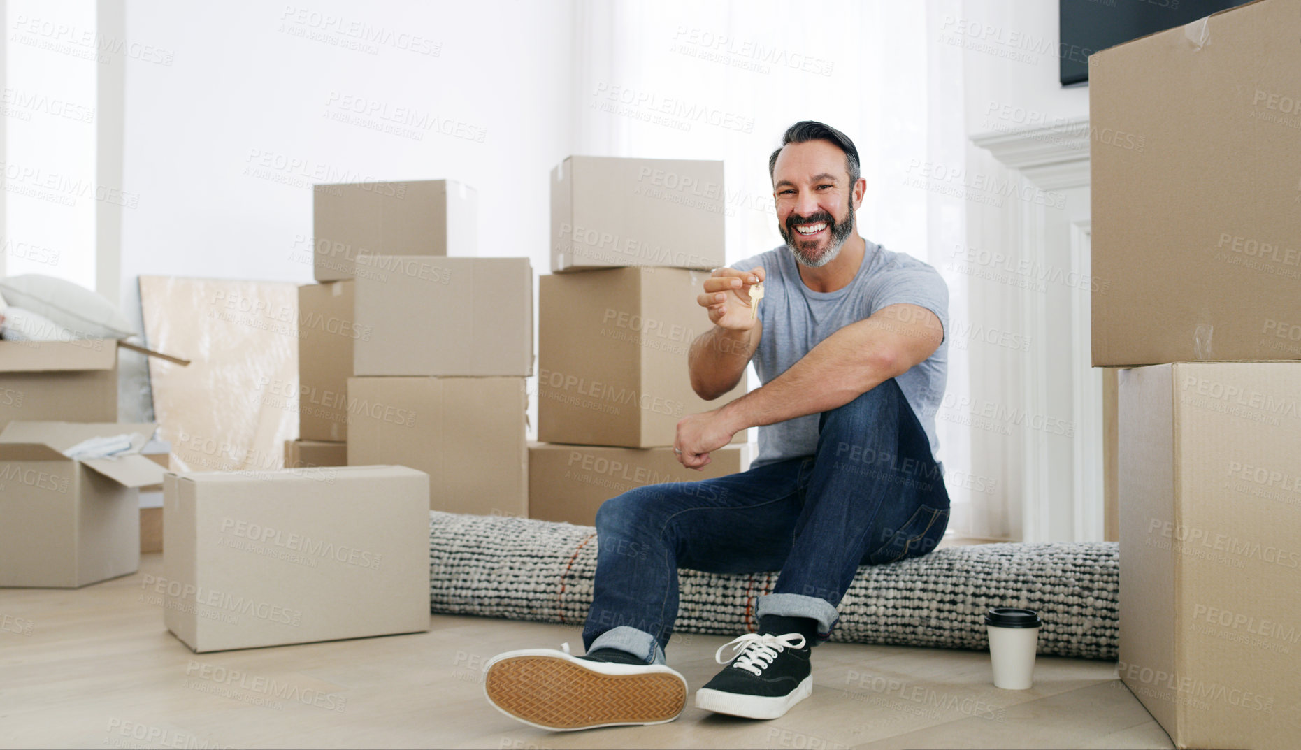 Buy stock photo Shot of a middle aged man holding the key to his new home