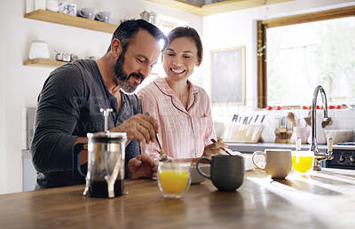 Buy stock photo Cropped shot of a middle aged couple having breakfast at home