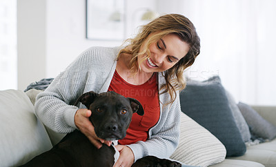 Buy stock photo Shot of a middle aged woman relaxing at home with her dog