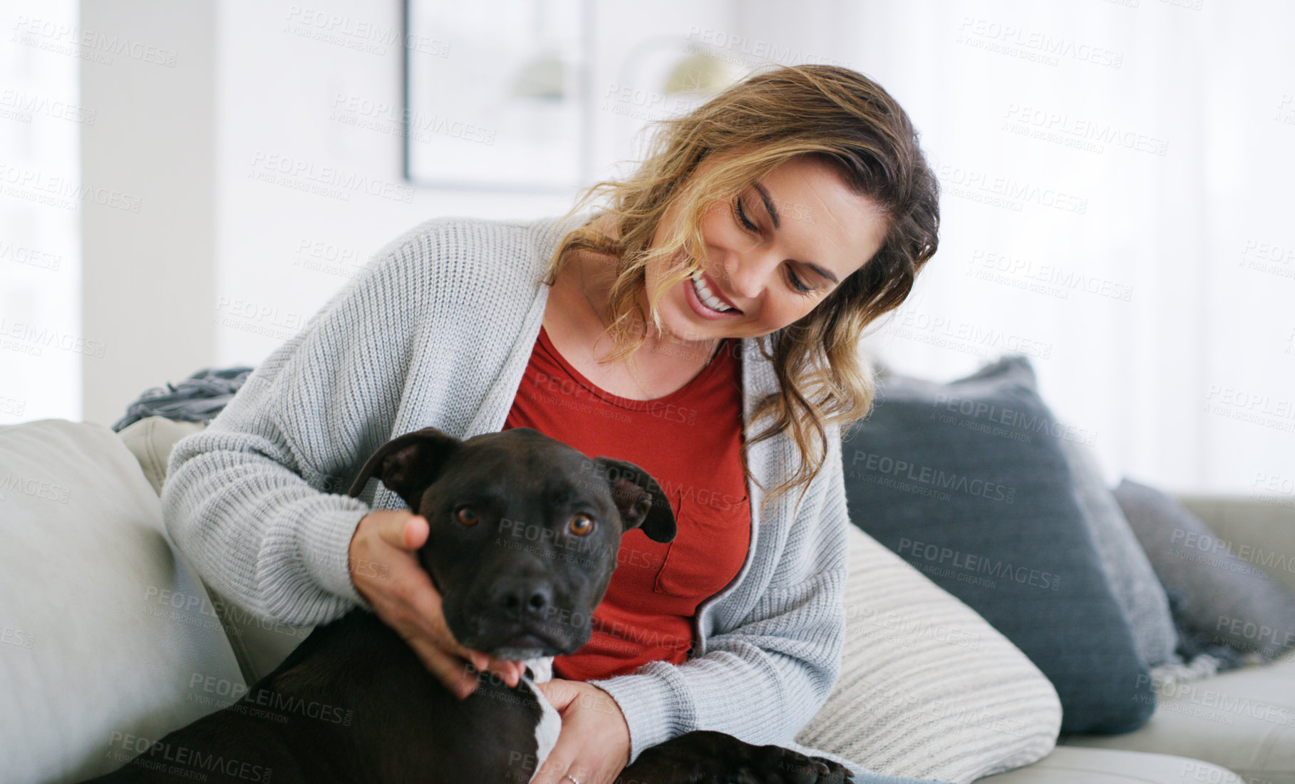 Buy stock photo Shot of a middle aged woman relaxing at home with her dog