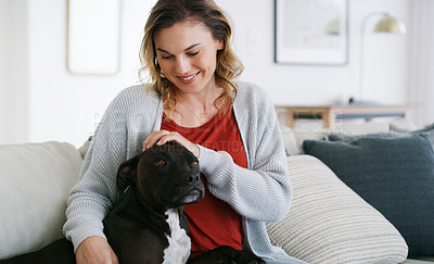 Buy stock photo Shot of a middle aged woman relaxing at home with her dog