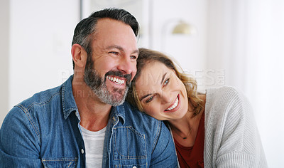 Buy stock photo Cropped shot of an affectionate couple relaxing together at home