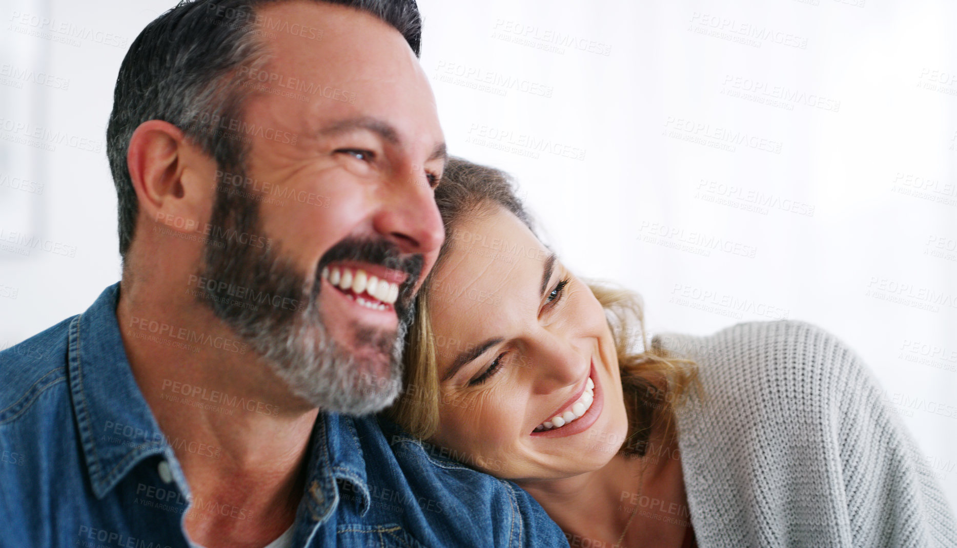 Buy stock photo Cropped shot of an affectionate couple relaxing together at home