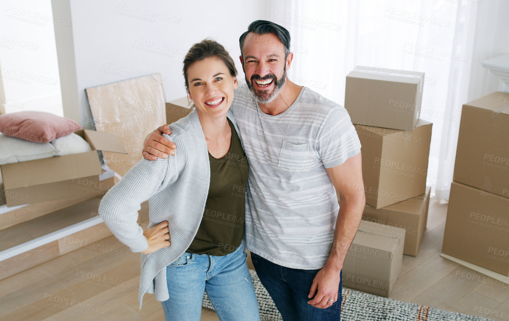 Buy stock photo Cropped shot of a middle aged couple moving into their new home