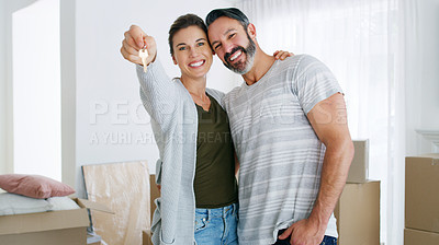 Buy stock photo Shot of a couple holding the key to their new home