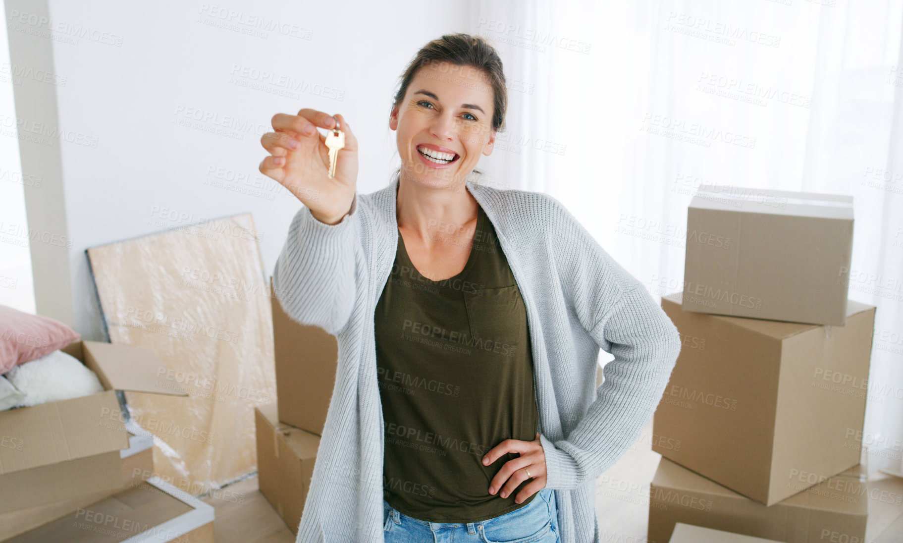 Buy stock photo Shot of a middle aged woman holding the key to her new home