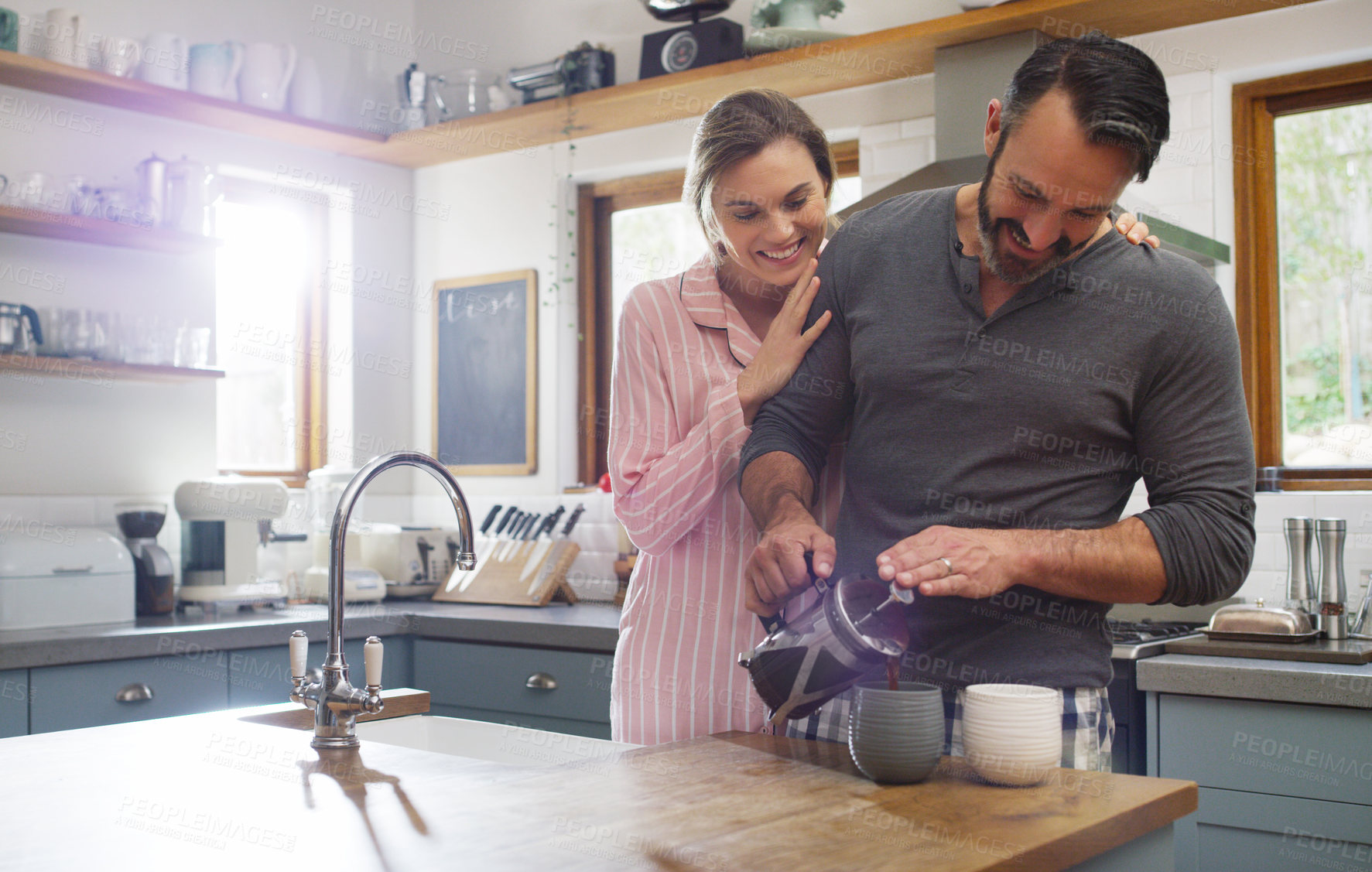 Buy stock photo Morning, coffee and happy with couple in kitchen for bonding, support and commitment. Love, connection and marriage with man and woman in home for relationship, weekend break and drink together