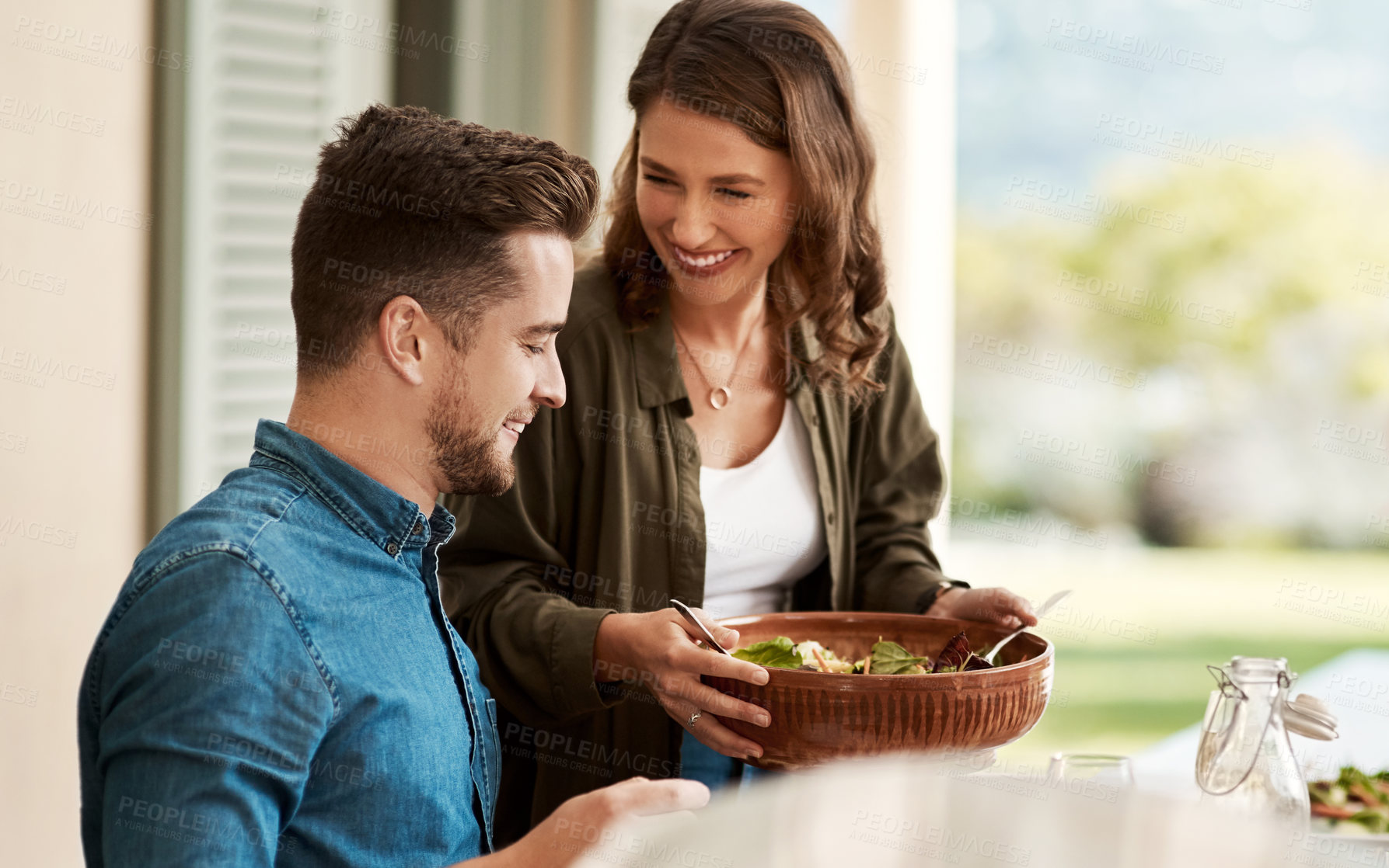 Buy stock photo Cropped shot of a couple enjoying a meal together in the yard at home