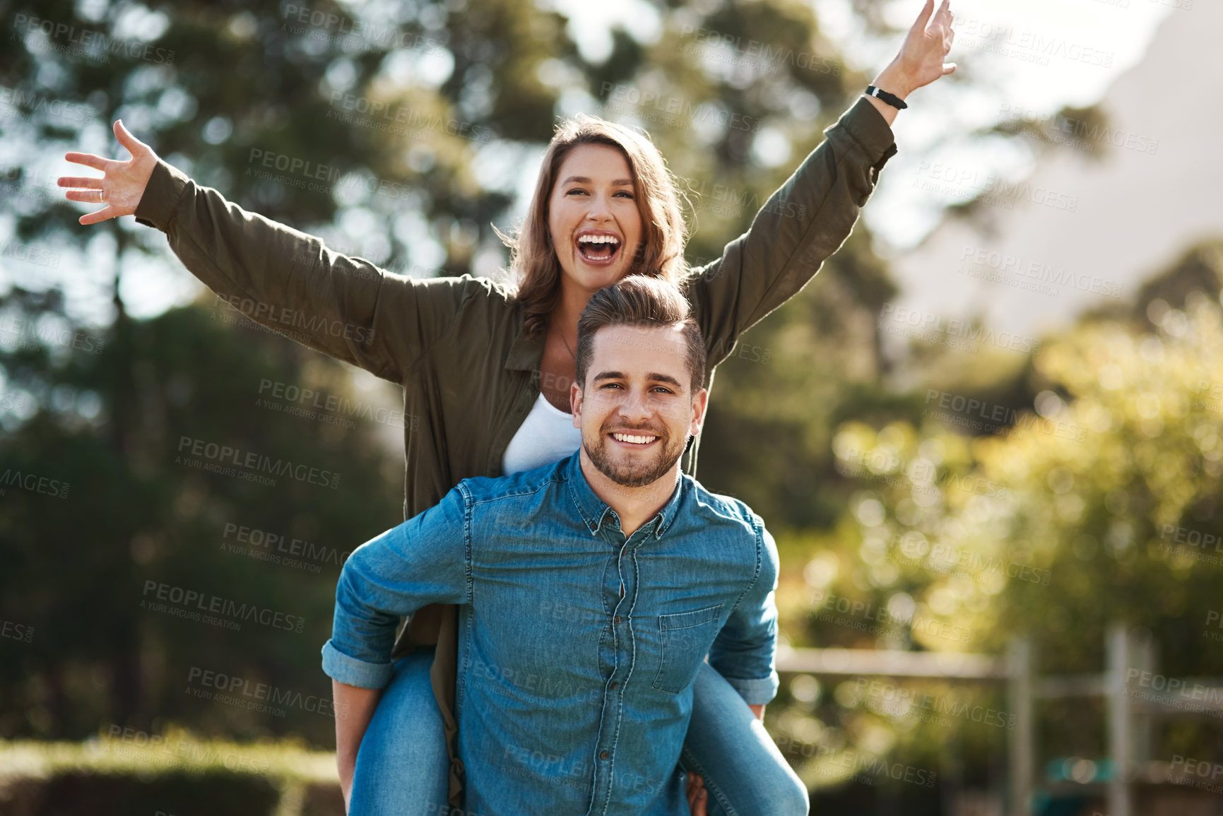 Buy stock photo Portrait, excited and couple with piggyback outdoor for summer freedom, marriage love and anniversary date. Smile, man and woman play for vacation travel, flying trust and bonding together in nature