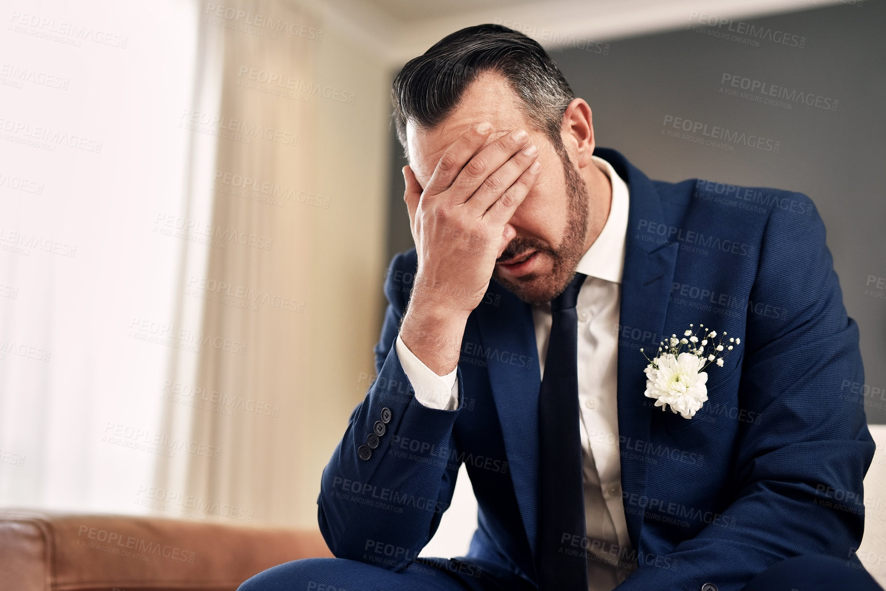 Buy stock photo Shot of a handsome mature bridegroom looking stressed and suffering from a headache on his wedding day
