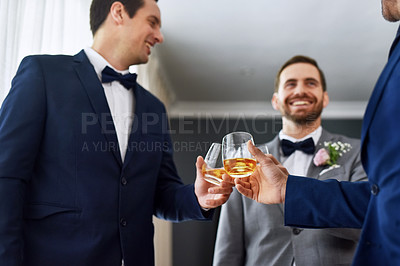 Buy stock photo Shot of two unrecognizable groomsmen sharing a toast with the bridegroom on his wedding day