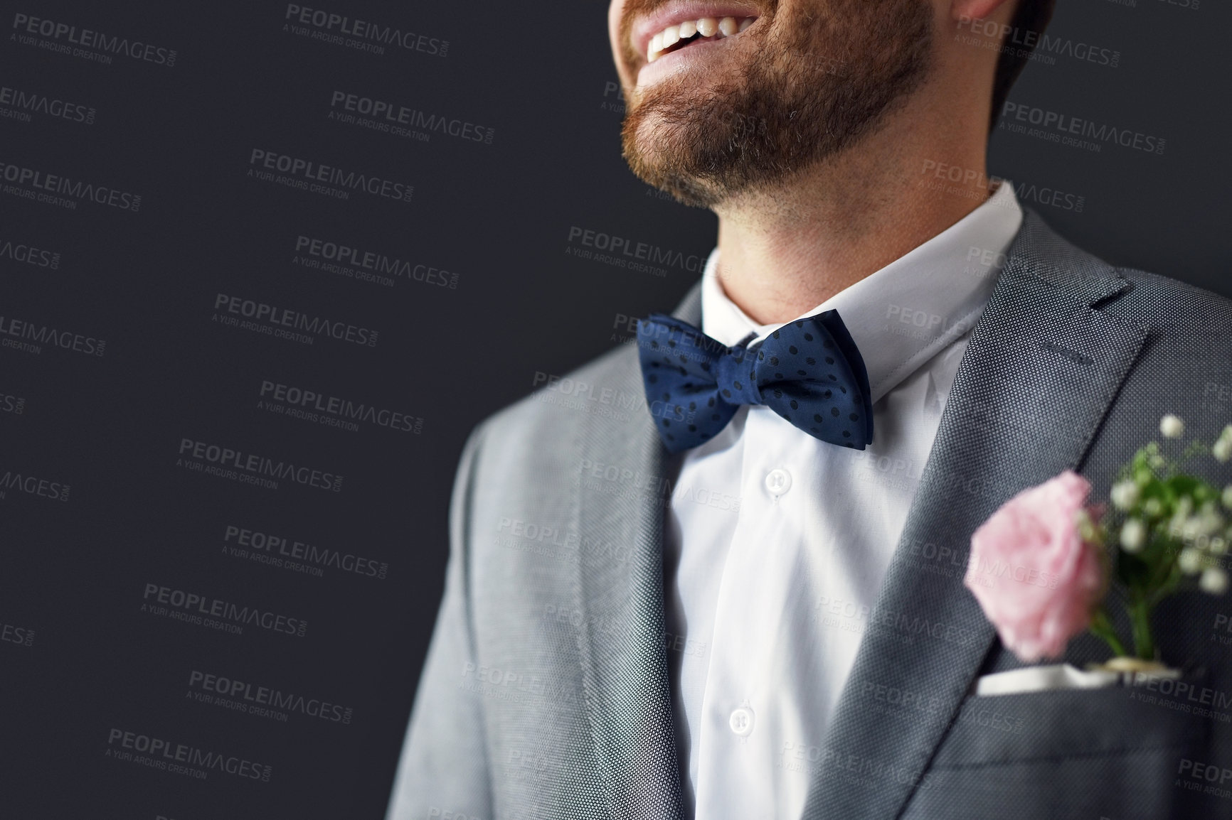 Buy stock photo Shot of an unrecognizable bridegroom smiling and feeling cheerful on his wedding day
