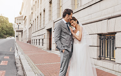 Buy stock photo Shot of a beautiful couple out in the city on their wedding day