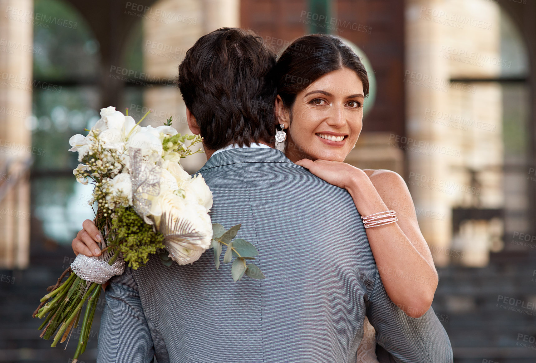 Buy stock photo Flowers, wedding and love with a married couple hugging outdoor together after a ceremony of tradition. Hug, marriage or commitment with a man and woman outside looking happy as husband and wife