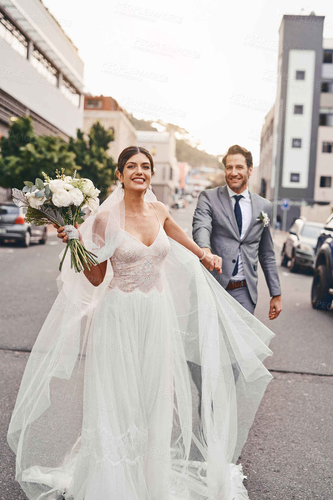 Buy stock photo Shot of a beautiful couple out in the city on their wedding day