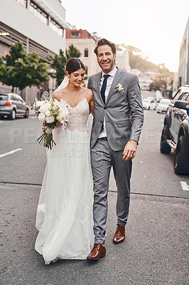 Buy stock photo Shot of a beautiful couple out in the city on their wedding day