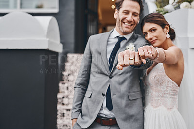 Buy stock photo Cropped shot of a newlywed couple showing off their rings