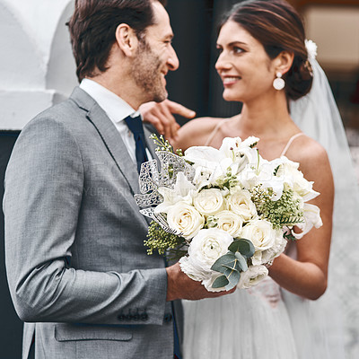 Buy stock photo Flowers, wedding and love with a married couple standing outdoor together after a ceremony of tradition. Love, marriage or commitment with a man and woman outside looking happy as husband and wife
