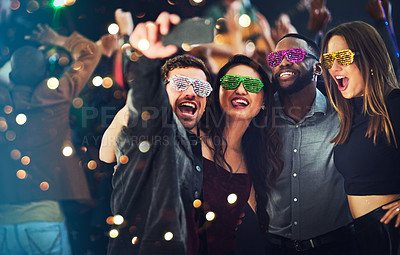 Buy stock photo New Years eve, party and group selfie with fun sunglasses and props while having fun and celebrating. Concert, festival and friends taking cellphone photo with wifi during celebration in a nightclub