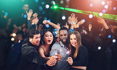 Buy stock photo Sparkler, new years eve and group of people celebrating and playing at social gathering party. Partying, friends and bright sparkle at disco event or nightclub celebration at a music festival