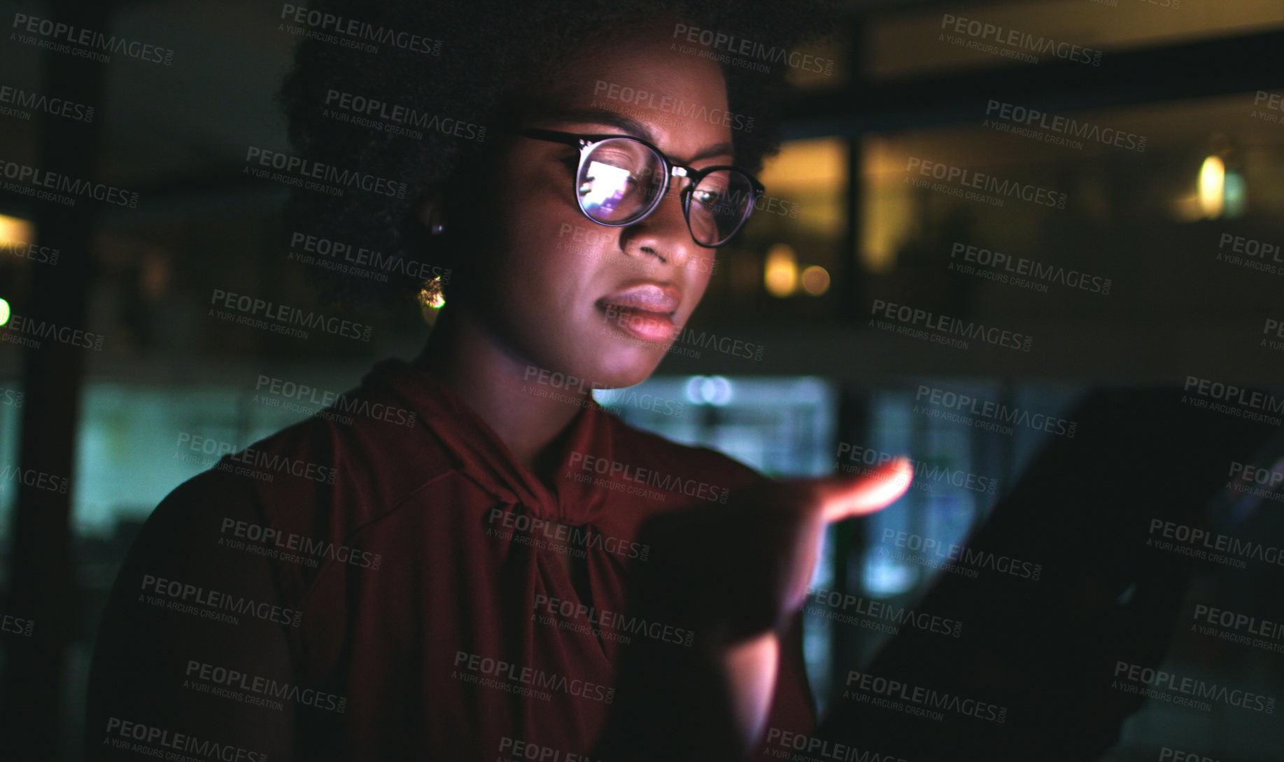 Buy stock photo Cropped shot of a businesswoman using a digital tablet while working late at the office
