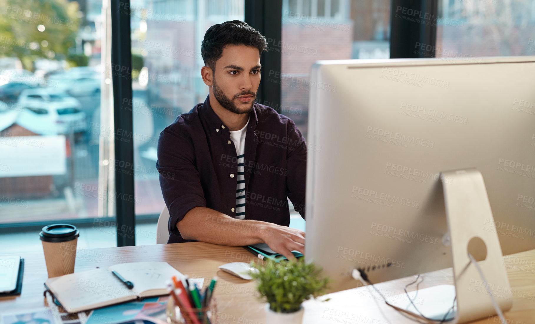 Buy stock photo Business, computer and man working at a desk while online for research or creative work. Male entrepreneur person at workplace with focus and internet connection for designer project or reading email