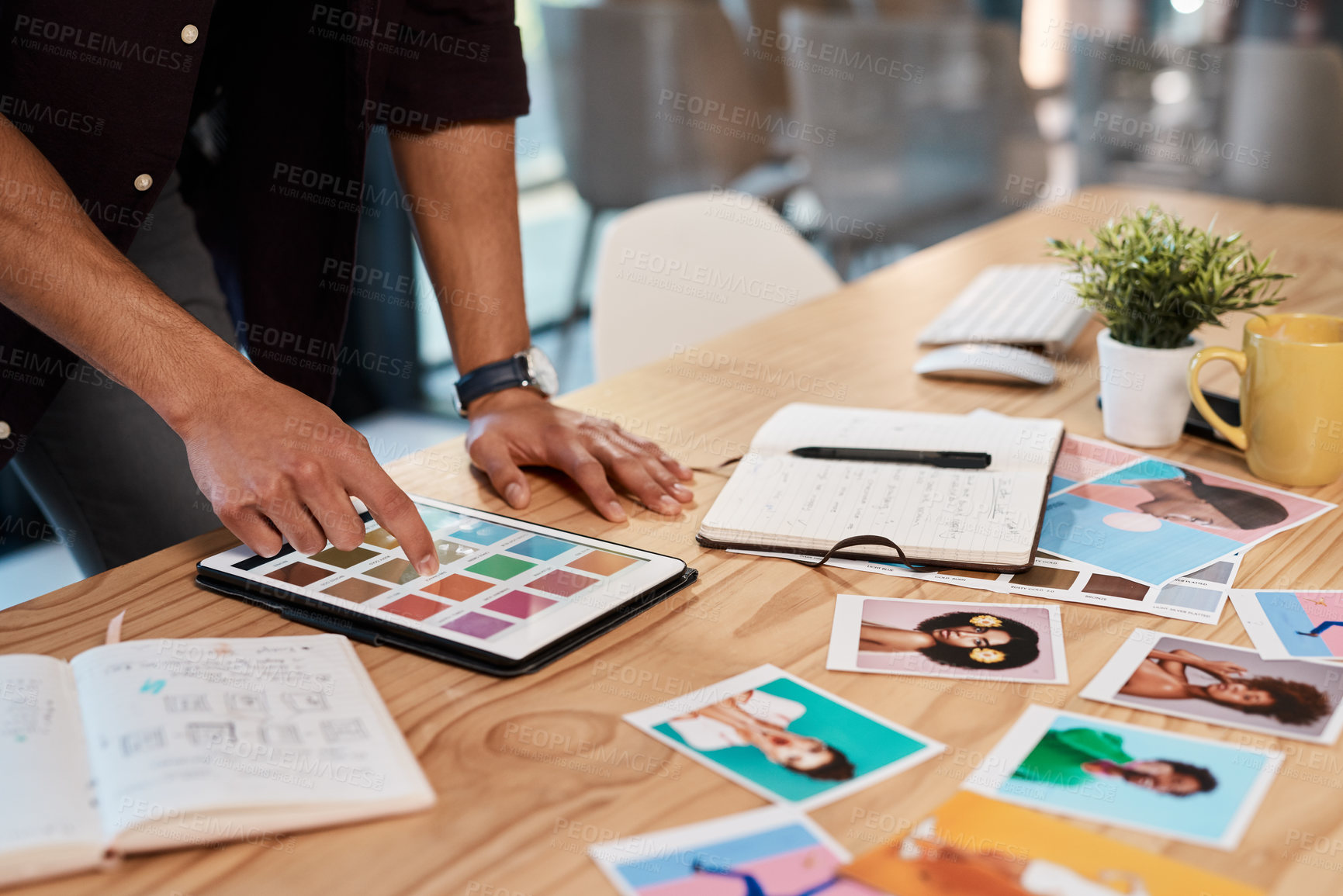 Buy stock photo Cropped shot of an unrecognizable businessman standing alone in his office and using a tablet to view colour swatches