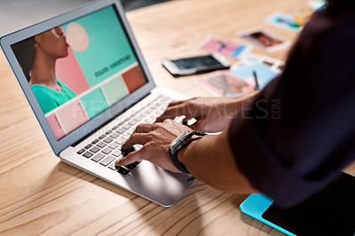 Buy stock photo Cropped shot of an unrecognizable businessman standing alone in his office and typing on his laptop