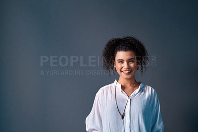 Buy stock photo Cropped portrait of an attractive young businesswoman standing against a gray background alone in the studio