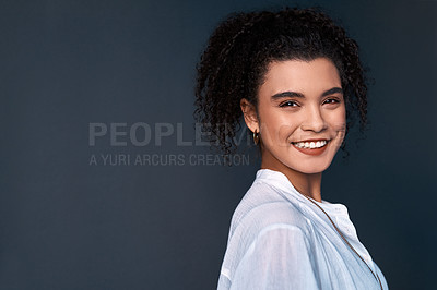 Buy stock photo Cropped portrait of an attractive young businesswoman standing against a gray background alone in the studio