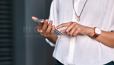 Buy stock photo Cropped shot of an unrecognizable businesswoman standing alone against a gray background and texting on her cellphone