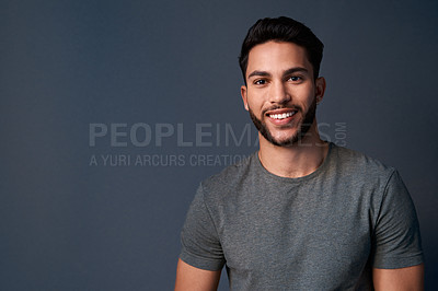 Buy stock photo Cropped portrait of a handsome young businessman standing against a gray background alone in the studio