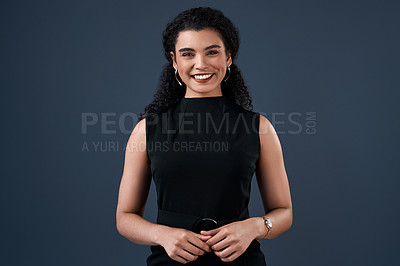 Buy stock photo Cropped portrait of an attractive young businesswoman standing alone against a gray background in the studio