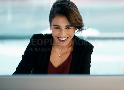 Buy stock photo Cropped shot of an attractive young businesswoman sitting alone and working on her computer in the office
