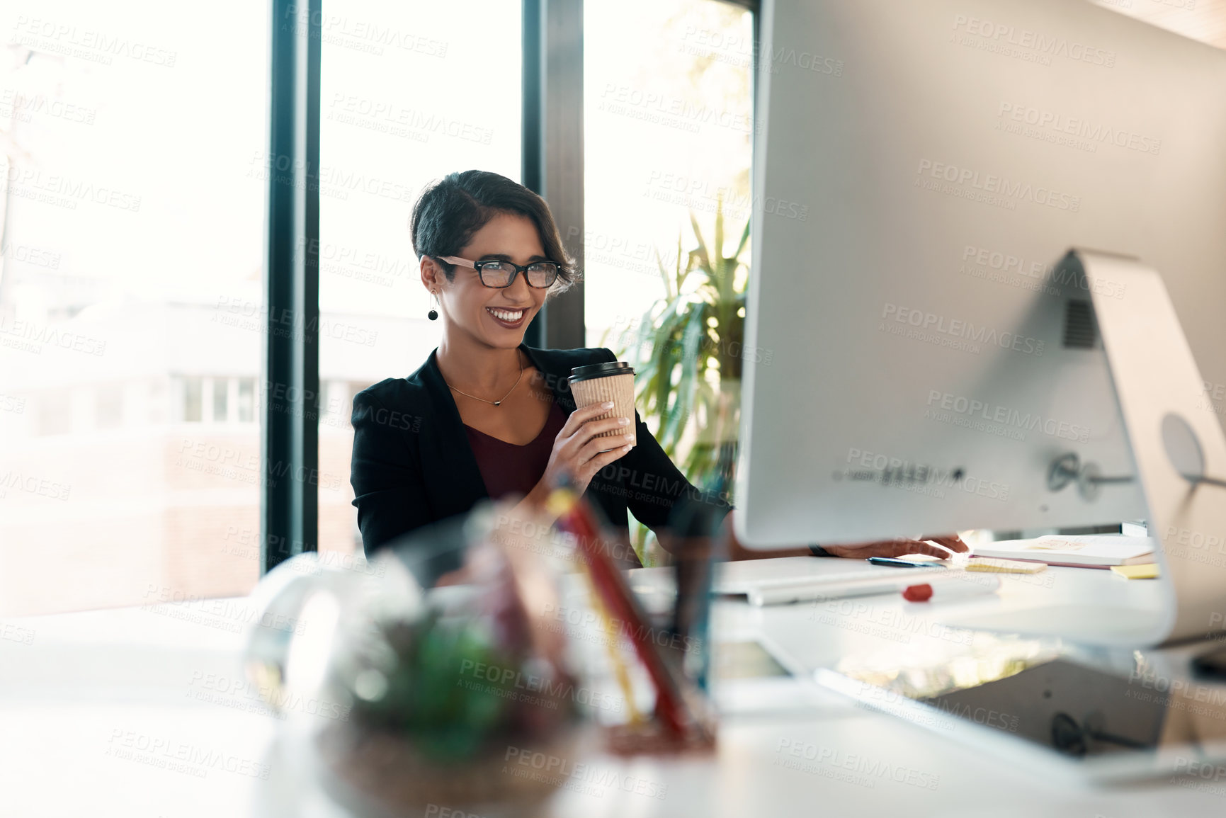 Buy stock photo Smile, drinking coffee and business woman on computer for project research, report or financial broker reading email in office. Desktop, tea and happy professional on internet for networking online