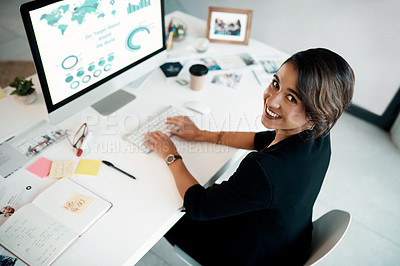 Buy stock photo Cropped portrait of an attractive young businesswoman sitting alone in her office and using her computer