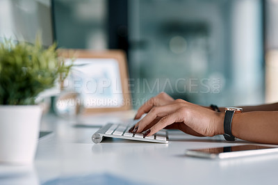Buy stock photo Cropped shot of an unrecognizable businesswoman sitting alone in her office and typing on her computer keyboard
