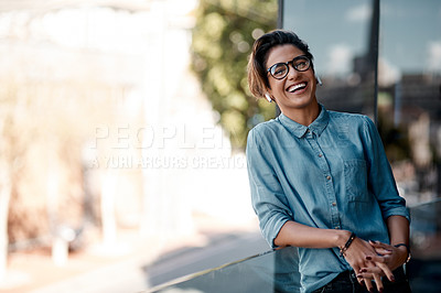 Buy stock photo Cropped portrait of an attractive young woman wearing earpods and standing on a balcony alone