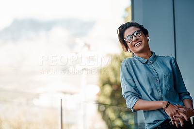 Buy stock photo Cropped shot of an attractive young woman wearing earpods and standing on a balcony alone