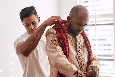 Buy stock photo Cropped shot of a young best man helping the groom with getting dressed on the wedding day